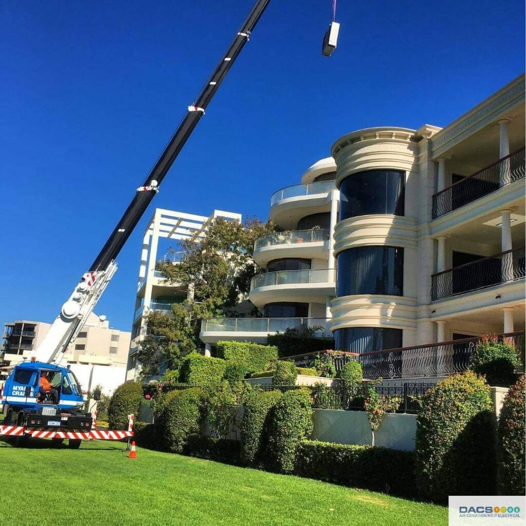 Crain installing a Air conditioning unit in Perth