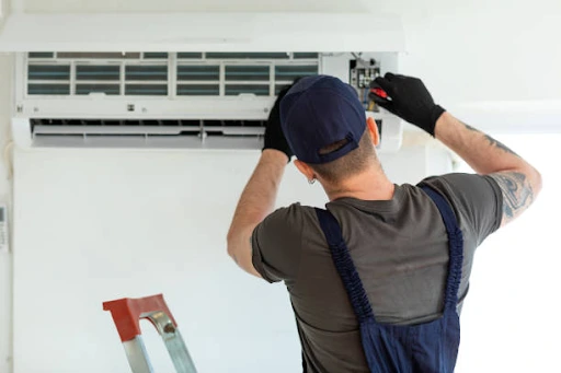 air con technician repairing wall unit