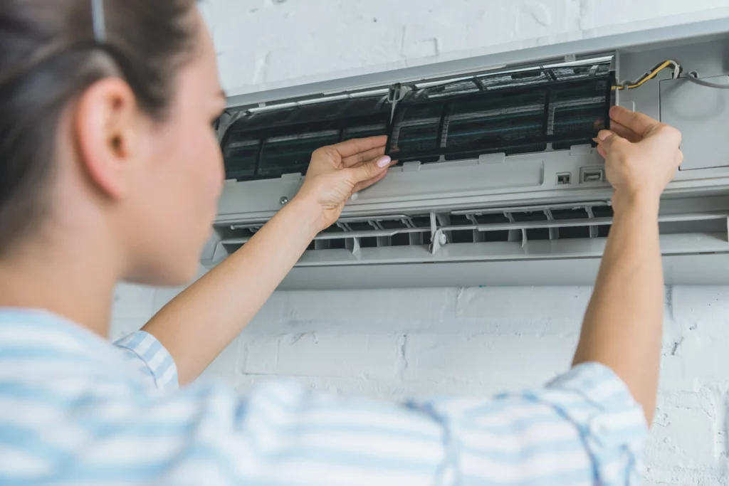 female worker repairing air con